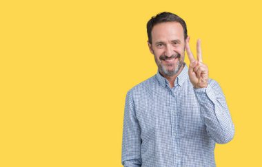 Yakışıklı orta yaş zarif komuta sizde gösterilen ve parmakları ile işaret izole arka plan üzerinde ikincisi ise kendinden emin ve mutlu gülümseyerek.