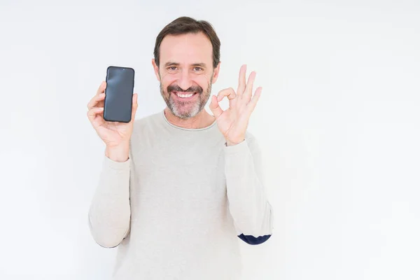 Senior Man Showing Smartphone Screen Isolated Background Doing Sign Fingers — Stock Photo, Image