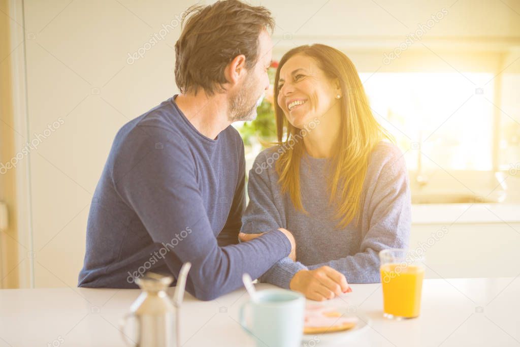 Beautiful romantic middle age couple having healthy breaskfast in the morning at home