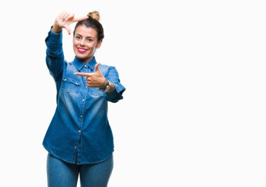 Genç güzel kadın elle yapma çerçeve ve parmakları ile mutlu yüz gülümseyen izole arka plan yüzünden. Yaratıcılık ve Fotoğrafçılık kavramı.