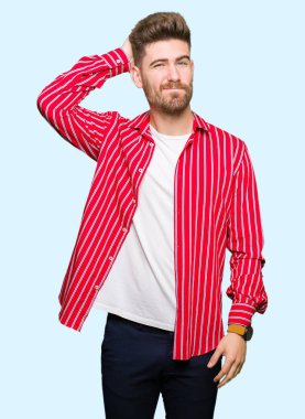 Kırmızı gömlek giymiş genç yakışıklı adam yanıltır ve soru hakkında merak ediyorum. Şüphe, kafasına el ile düşünme ile belirsiz. Dalgın kavramı.