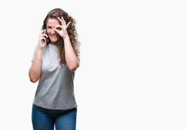 Smartphone ile mutlu yüz el parmaklarının arasından seyir göz üzerinde ok işaretiyle yapıyor gülümseyen izole arka plan üzerinde konuşurken genç esmer kız