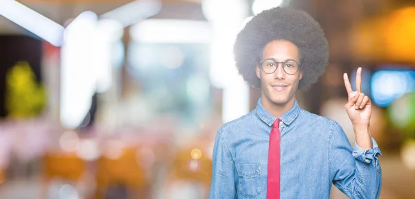 眼鏡と赤いネクタイ指数自信と幸せの笑みを浮かべてながら二人で上向きの表示とアフロの髪の若いアフリカ系アメリカ人ビジネス男 — ストック写真