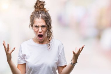 Güzel genç esmer kıvırcık saçlı kız üzerinde gözlük takan arka plan deli izole ve deli bağırarak ve agresif ifade ve silah kaldırdı bağırıyor. Hayal kırıklığı kavramı.