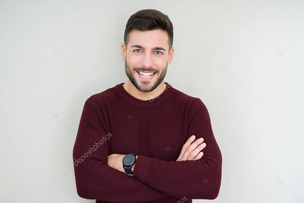Young handsome man wearing a sweater over isolated background happy face smiling with crossed arms looking at the camera. Positive person.