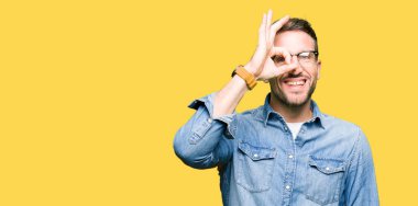 Yakışıklı adam gözlük el gülümseyen, ok jest yapıyor göz parmakları ile mutlu yüz üzerinden seyir.