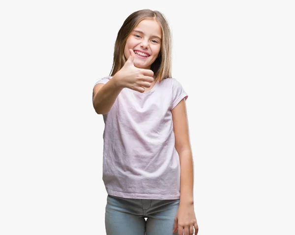 年轻美丽的女孩在孤立的背景下做快乐大拇指手势与手 批准表达式看相机与显示成功 — 图库照片