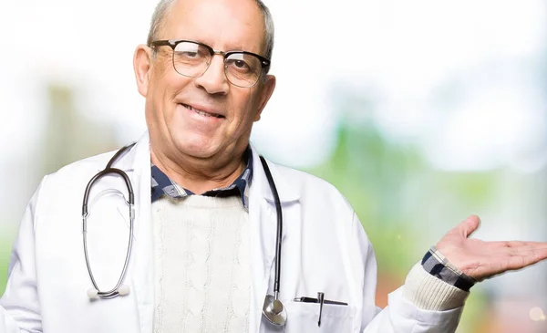 Bonito Médico Sênior Vestindo Casaco Médico Sorrindo Mostrando Ambas Mãos — Fotografia de Stock