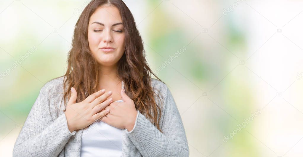 Beautiful plus size young woman wearing winter jacket over isolated background smiling with hands on chest with closed eyes and grateful gesture on face. Health concept.