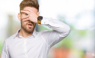 Yüz ve gözler el ile kapsayan şok bakmak genç yakışıklı iş adamı mahcup ifadeyle parmaklarımın arasından arıyorsunuz.