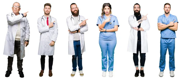一群医生和外科医生的人在白色被隔绝的背景指向旁边用手指显示广告 严肃和平静的面孔 — 图库照片