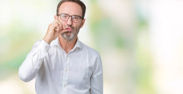 Handsome middle age elegant senior business man wearing glasses over isolated background mouth and lips shut as zip with fingers. Secret and silent, taboo talking