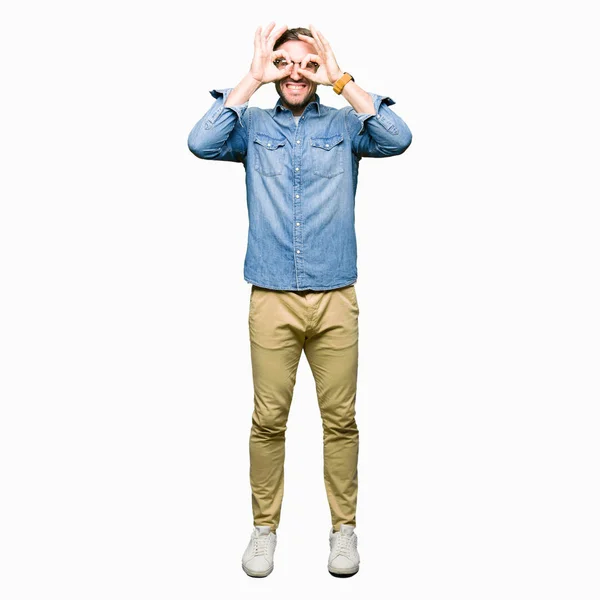 Handsome Man Wearing Glasses Doing Gesture Binoculars Sticking Tongue Out — Stock Photo, Image