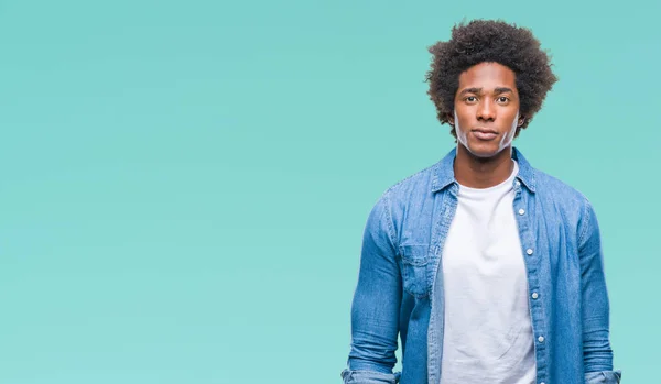 Afro american man over isolated background with serious expression on face. Simple and natural looking at the camera.