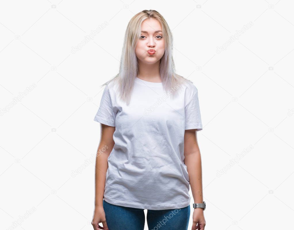 Young blonde woman over isolated background puffing cheeks with funny face. Mouth inflated with air, crazy expression.