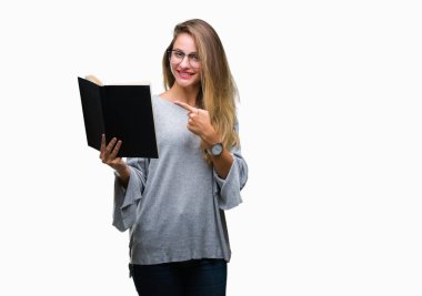 Genç güzel sarışın kadın izole arka el ve parmak ile işaret çok mutlu üzerine bir kitap okuma