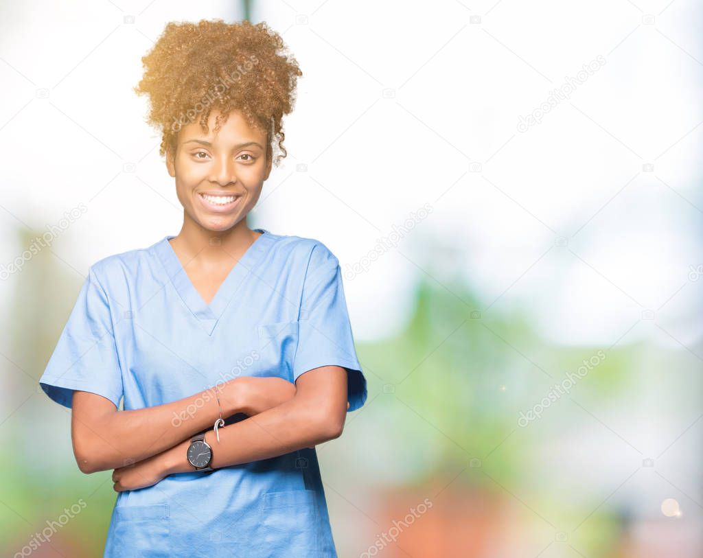 Young african american doctor woman over isolated background happy face smiling with crossed arms looking at the camera. Positive person.