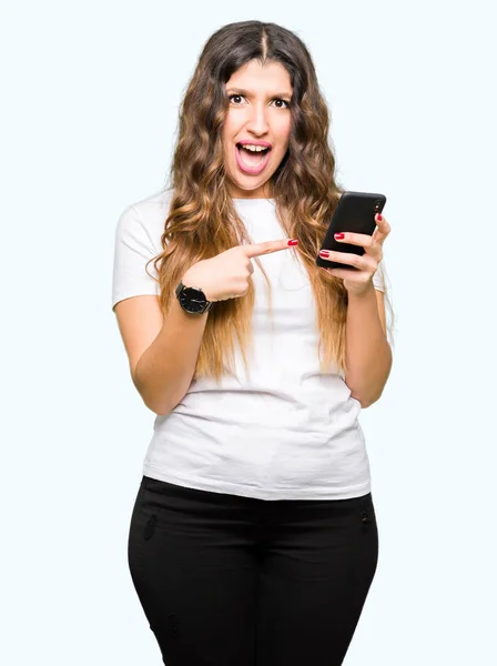 Young Adult Woman Using Smartphone Very Happy Pointing Hand Finger — Stock Photo, Image