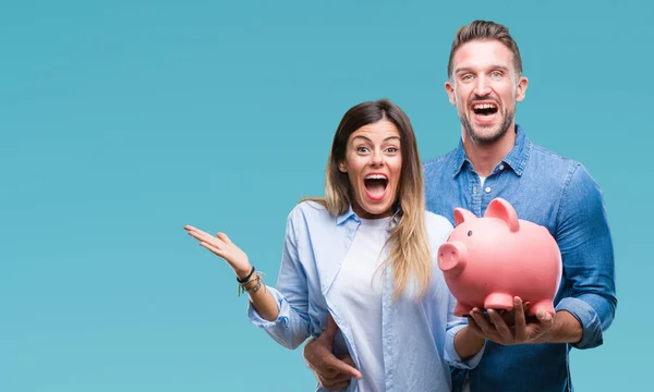 Jovem Casal Apaixonado Segurando Porquinho Banco Sobre Fundo Isolado Muito — Fotografia de Stock