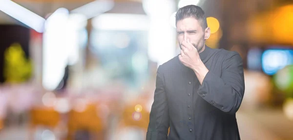 Young Christian Priest Isolated Background Smelling Something Stinky Disgusting Intolerable — Stock Photo, Image