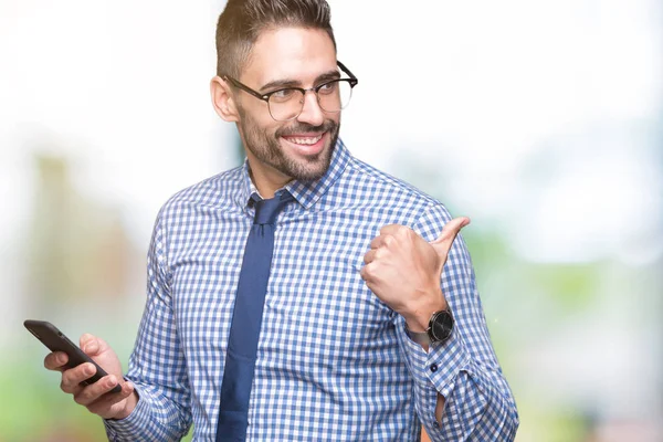 Young Business Man Using Smartphone Isolated Background Pointing Showing Thumb — Stock Photo, Image