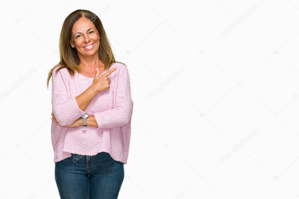 Beautiful middle age adult woman wearing winter sweater over isolated background cheerful with a smile of face pointing with hand and finger up to the side with happy and natural expression on face looking at the camera.