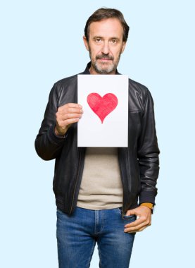 Kendinden emin bir ifade ile kırmızı kalp ile kağıt ciddi düşünme acımak yüz tutan yakışıklı orta yaş erkek