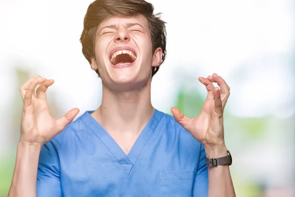 Joven Médico Vistiendo Uniforme Médico Sobre Fondo Aislado Celebrando Loco —  Fotos de Stock