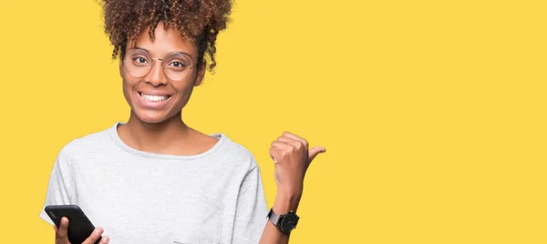 Young African American Woman Using Smartphone Isolated Background Pointing Showing — Stock Photo, Image