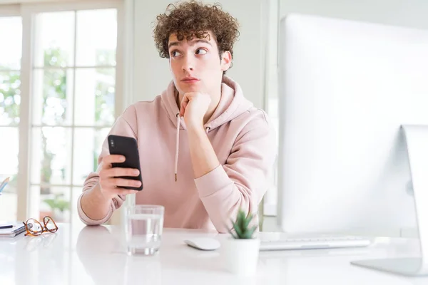 Young Student Man Using Smartphone Computer Serious Face Thinking Question — Stock Photo, Image