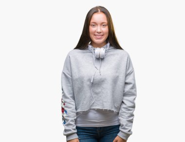 Yüzünde mutlu ve güzel bir gülümseme ile izole arka plan üzerinde kulaklık giyen genç güzel beyaz öğrenci kadın. Şanslı kişi.