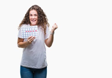 Duygu tezahürat adet takvim gurur çığlık ve zafer ve başarı çok heyecanlı, kutluyor izole arka plan üzerinde tutan genç esmer kız