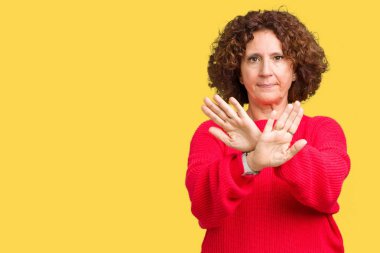 Güzel orta ager üst düzey kadın kırmızı kış kazak izole arka plan ret ifade geçiş silah ve avuç içi eksi işareti, kızgın surat yapıyor