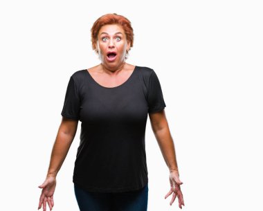 Atrractive üst düzey beyaz Kızıl saçlı kadın izole arka plan korkuyor ve sürpriz ifade, korku ve heyecan yüz ile şok yüzünden.