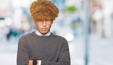 Genç yakışıklı iş adamı afro saçlı gözlük şüpheci ve sinir, onaylamayan ifade yüz çapraz kollu giyiyor. Negatif kişi.