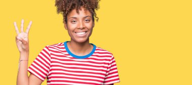 Gösterilen ve parmakları ile işaret izole arka plan güzel genç Afro-Amerikan kadın kendinden emin ve mutlu gülümseyerek iken üçüncü.