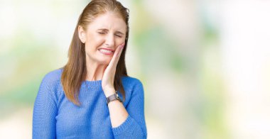 Diş ağrısı veya dişlerde dişlerle ilgili hastalık nedeniyle ağız acı ifadesi ile el ile dokunmak izole arka plan üzerinde kış kazak giyen güzel orta yaş Olgun kadın. Diş hekimi kavramı.