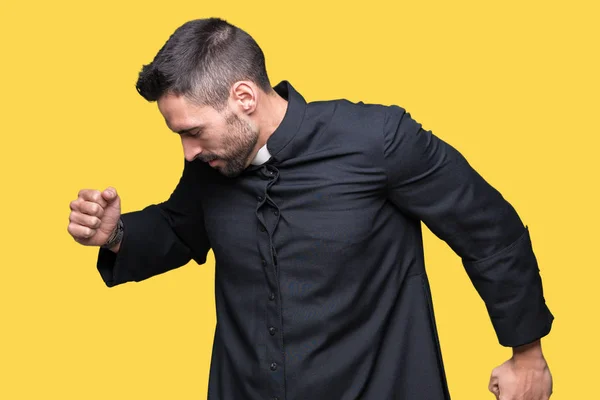 Young Christian priest over isolated background stretching back, tired and relaxed, sleepy and yawning for early morning