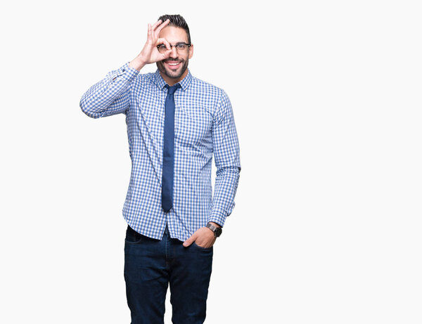 Young business man wearing glasses over isolated background doing ok gesture with hand smiling, eye looking through fingers with happy face.