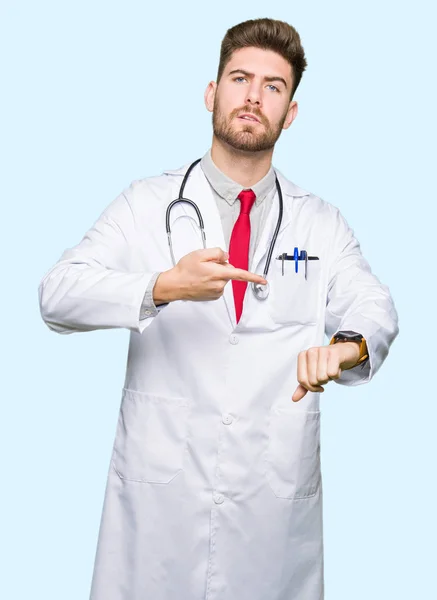 Young Handsome Doctor Man Wearing Medical Coat Hurry Pointing Watch — Stock Photo, Image