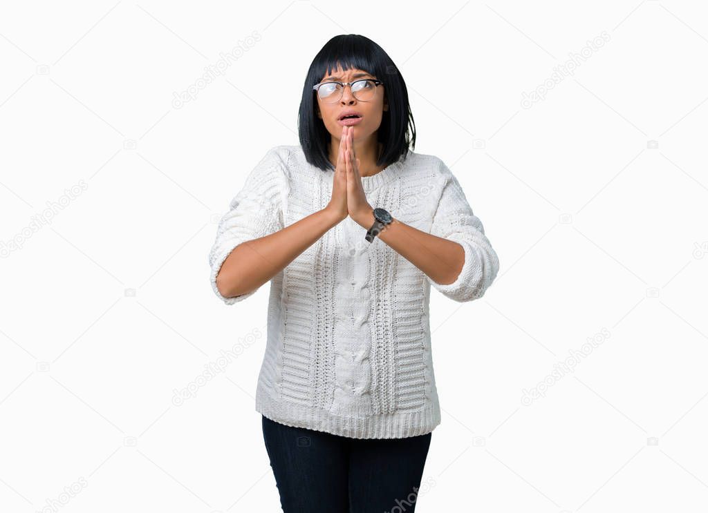 Beautiful young african american woman wearing glasses over isolated background begging and praying with hands together with hope expression on face very emotional and worried. Asking for forgiveness. Religion concept.