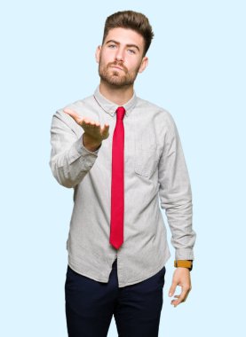 Genç yakışıklı iş adamı bir öpücük el ile güzel ve seksi olmak hava üfleme kamera bakıyor. Aşk ifade.