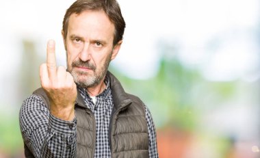 Orta yaş yakışıklı adam kış yeleği gösteren orta parmak, kaba ve kaba Siktir git ifade