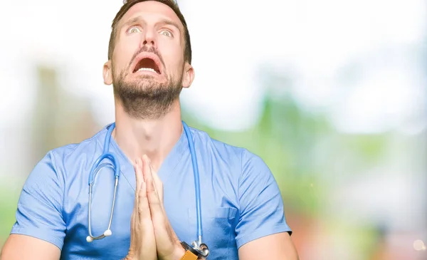 Handsome Doctor Man Wearing Medical Uniform Isolated Background Begging Praying — Stock Photo, Image