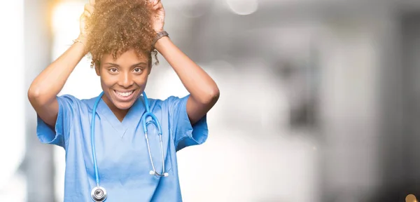 Young african american doctor woman over isolated background Posing funny and crazy with fingers on head as bunny ears, smiling cheerful