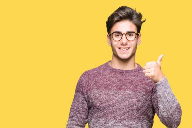 Hareketi el ile mutlu yaşasın yapıyor izole arka plan üzerinde gözlük takan yakışıklı delikanlı. Başarı gösteren kameraya bakarak ifade onaylama.