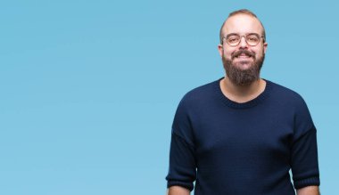 Genç beyaz hipster adam yüzünde mutlu ve güzel bir gülümseme ile izole arka plan üzerinde güneş gözlüğü takıyor. Şanslı kişi.