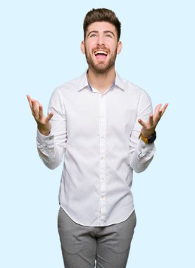 Genç yakışıklı iş adam çılgın ve kızgın bağırarak ve agresif ifade ve silah kaldırdı bağırıyordu. Hayal kırıklığı kavramı.