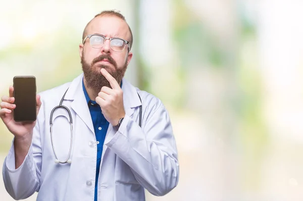 Young Doctor Man Showing Smartphone Screen Isolated Background Serious Face — Stock Photo, Image