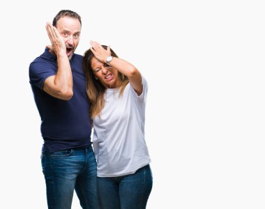 Orta yaş İspanyol rahat çift çünkü umutsuz ve stresli baş ağrısı acı izole arka plan üzerinde ağrı ve migren. Ellerini kafasına.